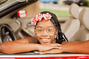 girl sitting in car smiling