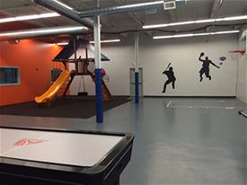 activity area with air hockey and basketball hoop