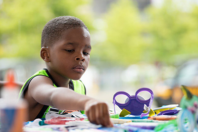 Boy sitting at table doing crafts