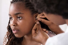 Young girl with hearing aid
